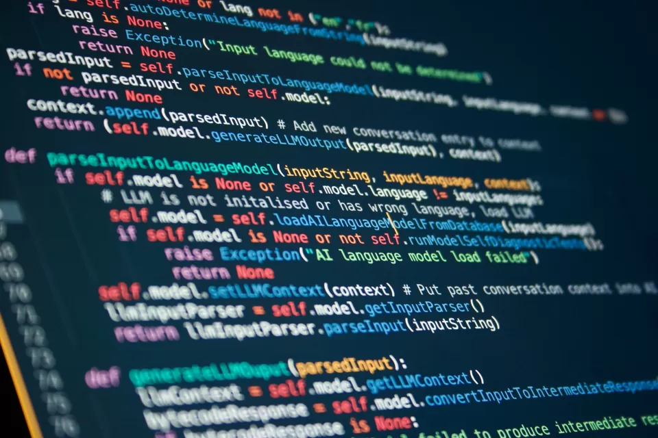Multicolored lines of code against a black screen.